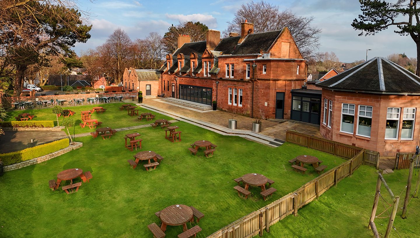 The lawn at The Balgarth Pines set out with wooden picnic tables